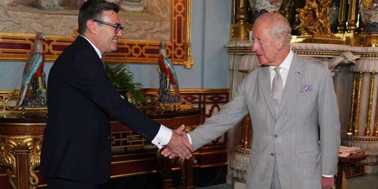Britain's King Charles III shakes hands with Britain's incoming Prime Minister Andy Burnham, during an audience at Buckingham Palace, London, where he invited the leader of the Labour Party to become Prime Minister and form a new government, on July 20, 2026 Transition at Downing Street: Starmer bows out, Andy Burnham to become PM