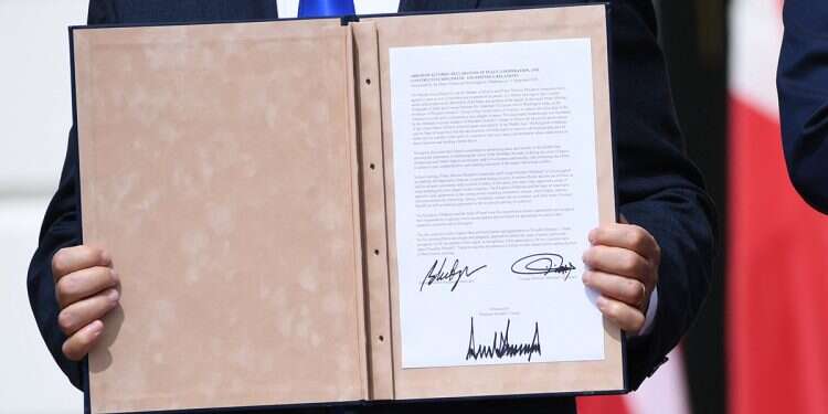 Netanyahu holds a copy of the agreement with Bahrain. Photo: AFP Arab state urged another to make peace with Israel as cover for war