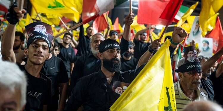 Hezbollah supporters wave the terrorist group’s flag and the Iranian flag in Beirut. Photo: Getty Images Hezbollah moves to undermine Lebanon-Israel framework agreement