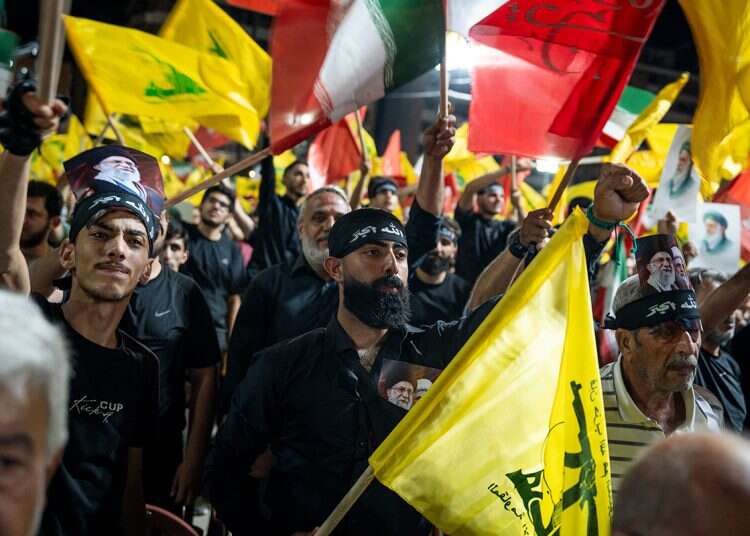 Hezbollah supporters wave the terrorist group’s flag and the Iranian flag in Beirut. Photo: Getty Images Hezbollah moves to undermine Lebanon-Israel framework agreement