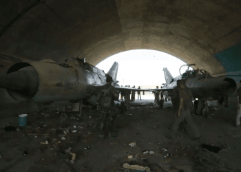 Syrian soldiers stand at a damaged military airfield Israel silent as US sharply rebukes strike on Syria