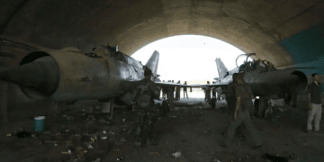 Syrian soldiers stand at a damaged military airfield Syria to keep nuclear material amid Idlib strikes