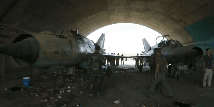 Syrian soldiers stand at a damaged military airfield Israel silent as US sharply rebukes strike on Syria