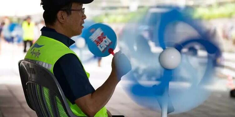 A Seoul municipal safety officer oversees efforts to help residents stay cool during South Korea’s severe heat wave. Photo: AP Seoul declares emergency as record heat wave grips South Korea