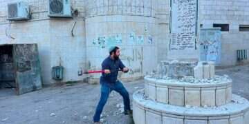 Tzvi Sukkot after taking a sledgehammer to destroy a terrorist shrine MK takes sledgehammer to Palestinian town – smashes terror shrines