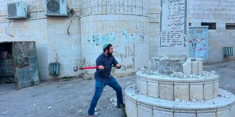 Tzvi Sukkot after taking a sledgehammer to destroy a terrorist shrine MK takes sledgehammer to Palestinian town – smashes terror shrines