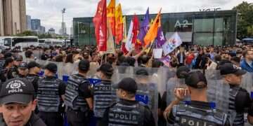 People surrounded by riot police as they gather outside Caglayan Courthouse, known as the Justice Palace, in solidarity with the LGBTQ+ community and to protest a government campaign that has included sweeping raids on LGBTQ+ associations, in Istanbul, Turkey, September 15, 2026. Turkey escalates crackdown on LGBTQ+ activists
