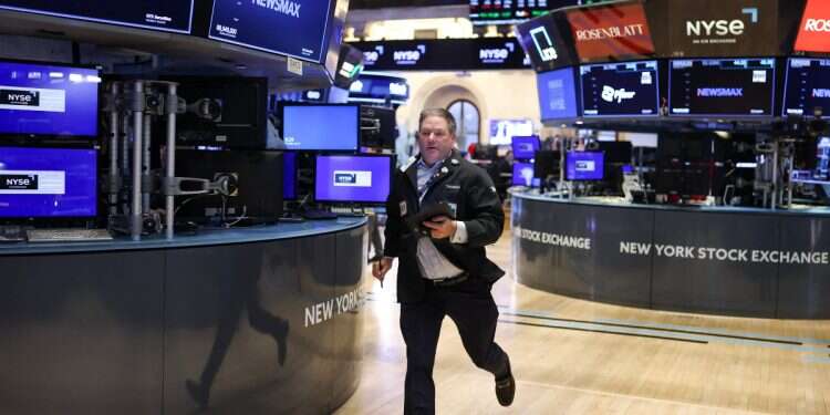 A trader runs on the floor of the New York Stock Exchange (NYSE) at the opening bell in New York City on April 3, 2025 Tech stocks bleed, oil spikes as dual crises hammer investors