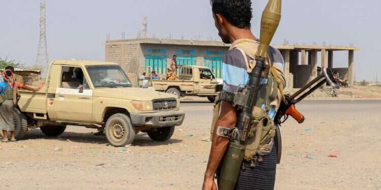 Forces loyal Yemen's Saudi-backed government stand near a pick-up truck in the Hays district, south of Hodeidah on September 5, 2026 Yemen government forces capture Houthi base amid multi-front battles