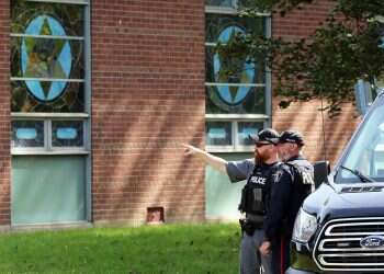 Police stand in front of the Son of Jacob Synagogue in Belleville, Ontario Ontario on Monday Sept. 21, 2026 after the Yom Kippur attack earlier that day 'Cop saved everyone's life': Outpouring of support for Belleville hero