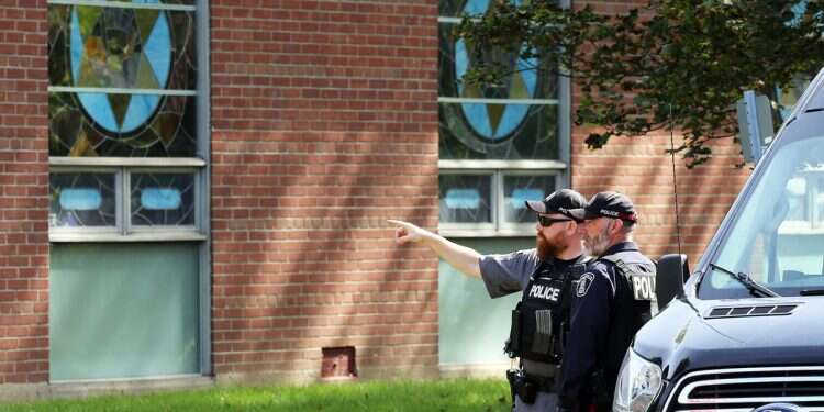 Police stand in front of the Son of Jacob Synagogue in Belleville, Ontario Ontario on Monday Sept. 21, 2026 after the Yom Kippur attack earlier that day 'Cop saved everyone's life': Outpouring of support for Belleville hero