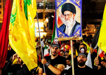 Hezbollah flags and a placard of former Supreme Leader Ali Khamenei are raised during a rally in Beirut, Lebanon Israel braces for possible Hezbollah flare-up