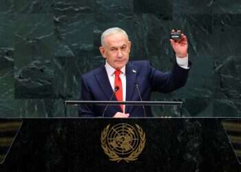 Prime Minister Benjamin Netanyahu holds up a pager as he addresses the 81st United Nations General Assembly at UN headquarters in New York City, US, September 24, 2026. Israeli banned from hackathon over concerns pagers may 'explode in participants' faces'