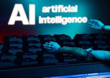 A message reading 'AI artificial intelligence', a keyboard, and robot hands are seen in this illustration taken January 27, 2025. Inside the growing fear that AI could wipe out humanity