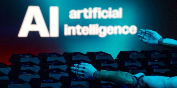 A message reading 'AI artificial intelligence', a keyboard, and robot hands are seen in this illustration taken January 27, 2025. Inside the growing fear that AI could wipe out humanity