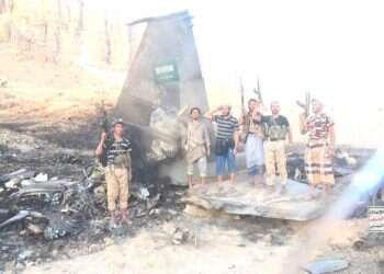 Houthi operatives stand on what the terrorist group claims are remains of a Saudi F-15 Houthis claim downing of Saudi F-15, release video of burning wreckage