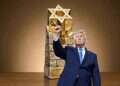 US President Donald Trump pumps his fist as he leaves the stage after delivering remarks during the Faith & Freedom Coalition's 2026 Policy Conference at the Washington Hilton on June 26, 2026 (background: The special statuette Trump will receive upon collecting the Israel Prize) 75000 shekels are waiting in Jerusalem – for Trump