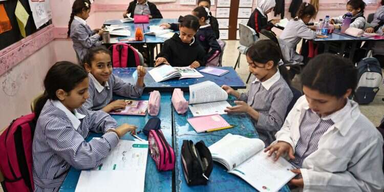 Palestinian children attend class at a United Nations Relief and Works Agency for Palestine Refugees (UNRWA) run school in the Qalandia refugee camp in the occupied West Bank on November 14, 2024 UNRWA teacher says she was silenced after challenging anti-Jewish lessons