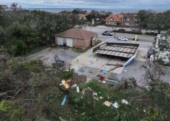A drone view shows the fallen roof and strewn debris of a gas station in the aftermath of Hurricane Isaias in Gulf Breeze, Florida, October 10, 2026 Hurricane Isaias death toll rises to four as power outages hit south Florida