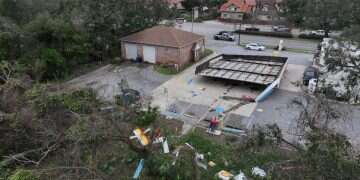 A drone view shows the fallen roof and strewn debris of a gas station in the aftermath of Hurricane Isaias in Gulf Breeze, Florida, October 10, 2026 Deadly Isaias hurricane kills 4, cuts power to hundreds of thousands