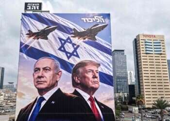 An aerial view shows a campaign billboard depicting Prime Minister Benjamin Netanyahu of the Likud party and US President Donald Trump in Tel Aviv on October 26, 2026 'Strike in Iran – a matter of days': Arab world reacts to election