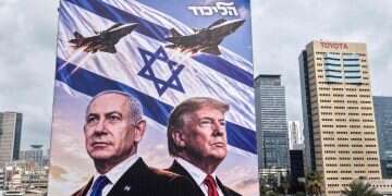 An aerial view shows a campaign billboard depicting Prime Minister Benjamin Netanyahu of the Likud party and US President Donald Trump in Tel Aviv on October 26, 2026 'Strike in Iran – a matter of days': Arab world reacts to election