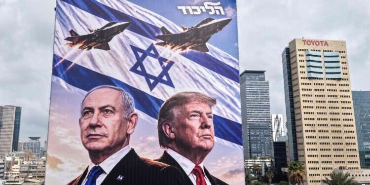 An aerial view shows a campaign billboard depicting Prime Minister Benjamin Netanyahu of the Likud party and US President Donald Trump in Tel Aviv on October 26, 2026 'Strike in Iran – a matter of days': Arab world reacts to election