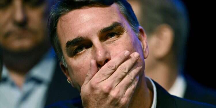 Brazil's right-wing presidential candidate and Senator Flavio Bolsonaro gestures during a press conference in Brasilia on August 5, 2026 Flavio Bolsonaro leaves Brazil for US after shock loss to Lula