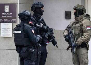 Members of Serbia's Gendarmerie stand guard at the entrance to the Israeli embassy in Belgrade on October 28, 2026, after a police officer stationed at the mission was attacked with two knives shortly after midnight (Andrej ISAKOVIC / AFP) Serbia raises terror threat after attack on elite guard at Israeli Embassy