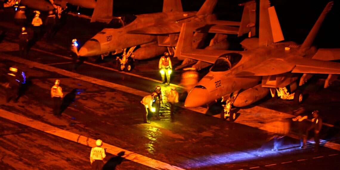 18 Super Hornets stand ready for launch on the flight deck of US Navy Nimitz-class aircraft carrier USS George Washington, en route to support U.S. military operations in the war with Iran, while operating in the Indian Ocean August 18, 2026. Washington prepares Gulf Arab nations for possible Iran strikes after midterms