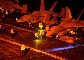 18 Super Hornets stand ready for launch on the flight deck of US Navy Nimitz-class aircraft carrier USS George Washington, en route to support U.S. military operations in the war with Iran, while operating in the Indian Ocean August 18, 2026. Washington prepares Gulf Arab nations for possible Iran strikes after midterms